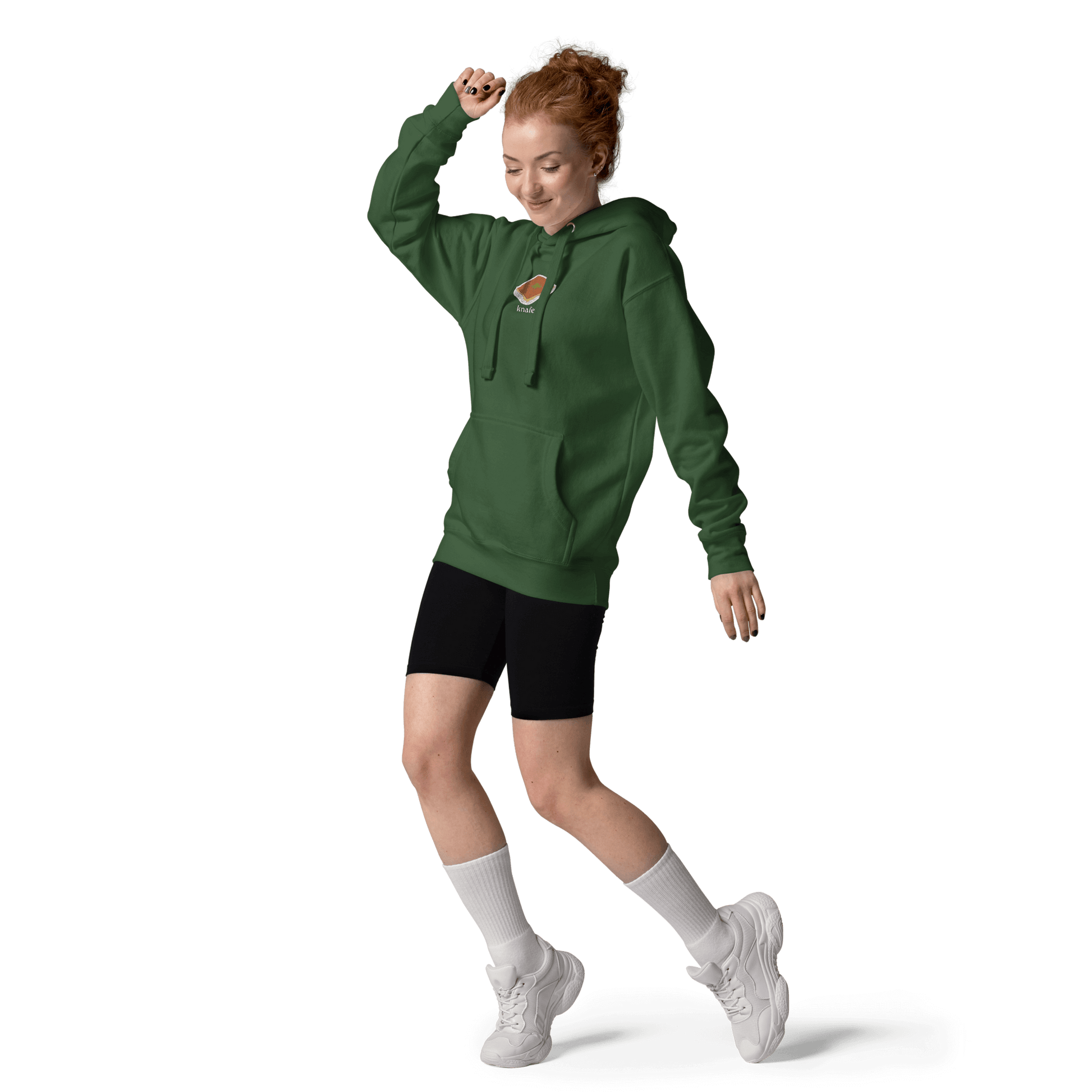 model wearing forest green knafeh hoodie outdoors