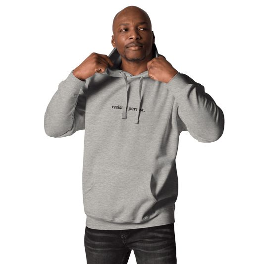model wearing grey resist & persist hoodie in urban setting