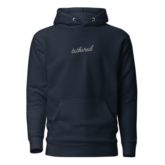navy blue tethered hoodie showing embroidered tethered logo